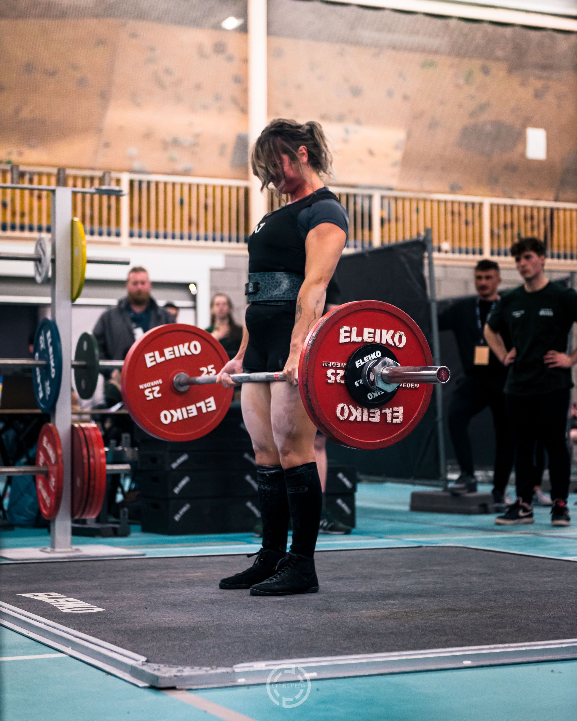 Woman doing a deadlift in a powerlifting competition. Eleiko powerlifting equipment. Odin Cup. Professional photography editing 